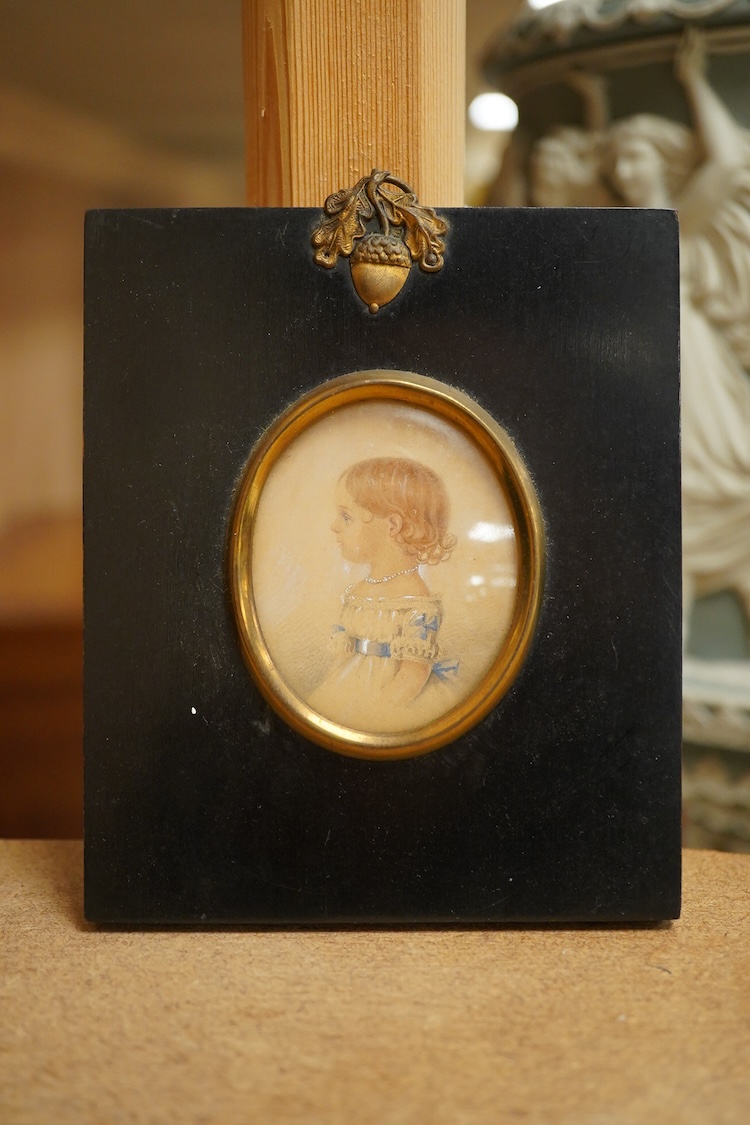 Regency School, Oval portrait miniature of a young girl in profile, watercolour on card, housed in an ebonised and gilt frame, overall 12 x 10cm